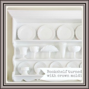 Image A neatly organized white bookshelf displaying an assortment of white dishware and decorative items, accentuated by elegant crown molding.