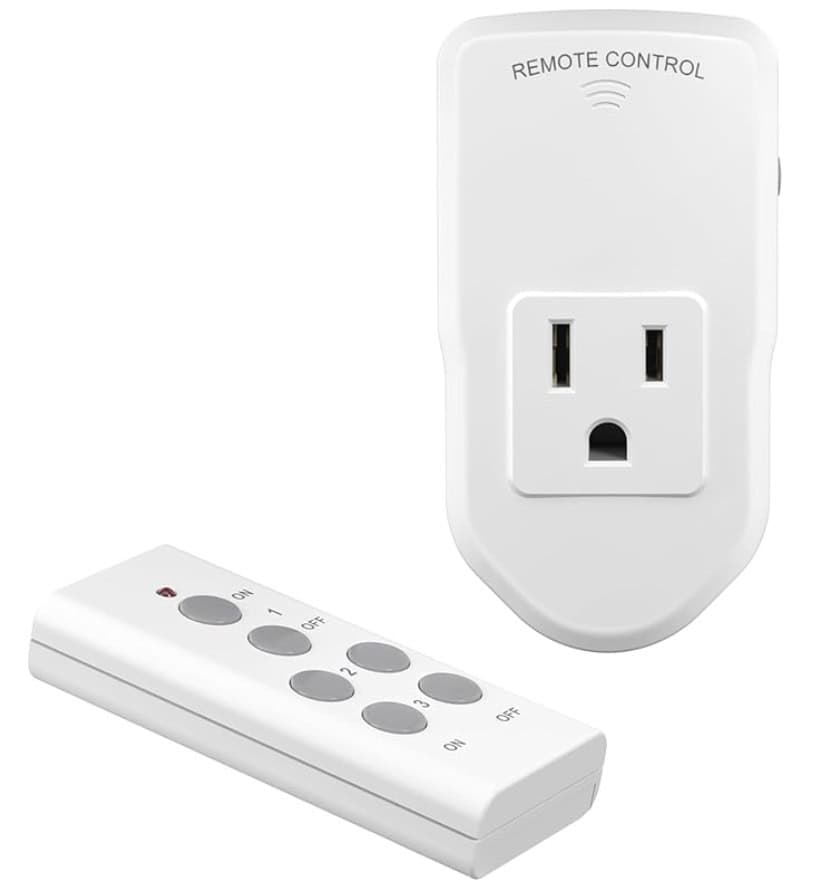 A white remote-control electrical outlet with a matching remote. The outlet has a standard plug socket and a small indicator, while the remote features multiple gray buttons labeled with "ON" and "OFF.