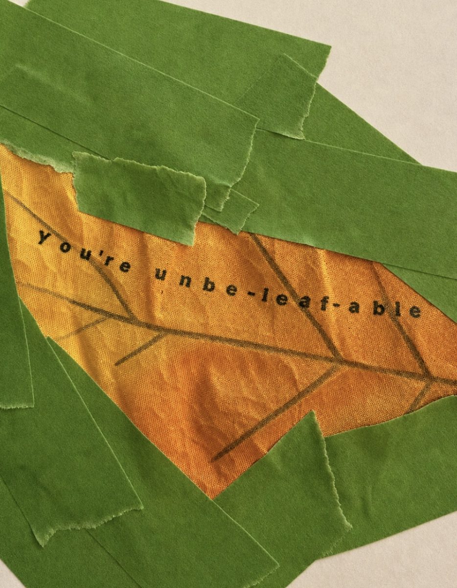 A yellow-orange paper leaf with the words “You’re unbe-leaf-able” is surrounded by torn green paper pieces on a light background.